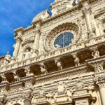 a tall building with a clock on the front of it