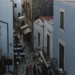 people walking on sidewalk near building during daytime