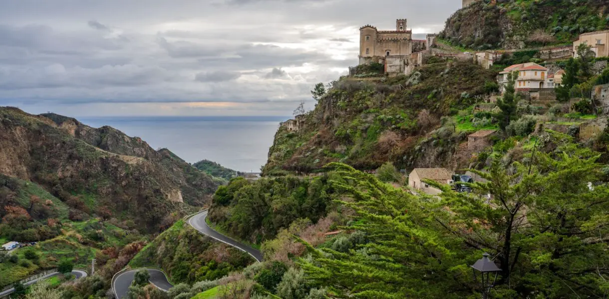 a scenic view of a winding road in the mountains