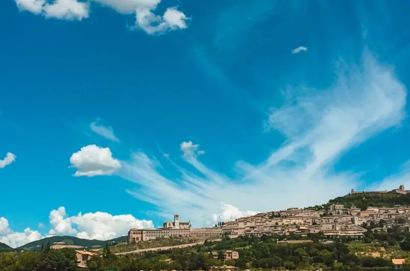 grass field near buildings under blue sky