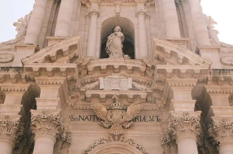A very tall building with a clock on it's side