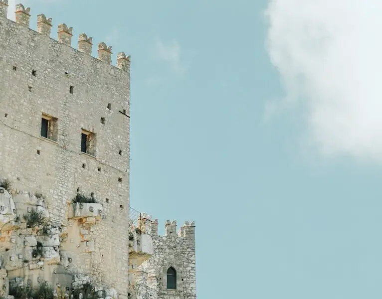 gray concrete castle under white cloudy blue sky