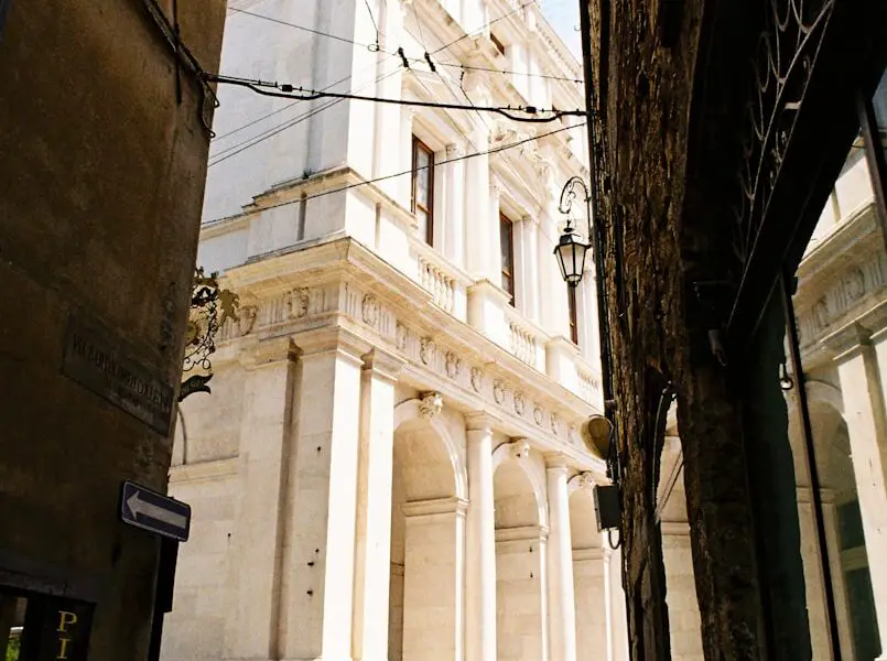 a group of people walking down a street next to a tall building