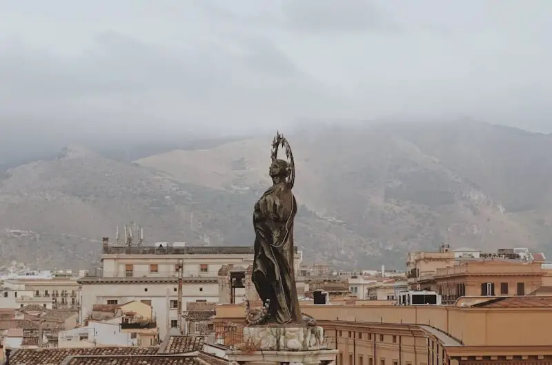 statue of man on top of building