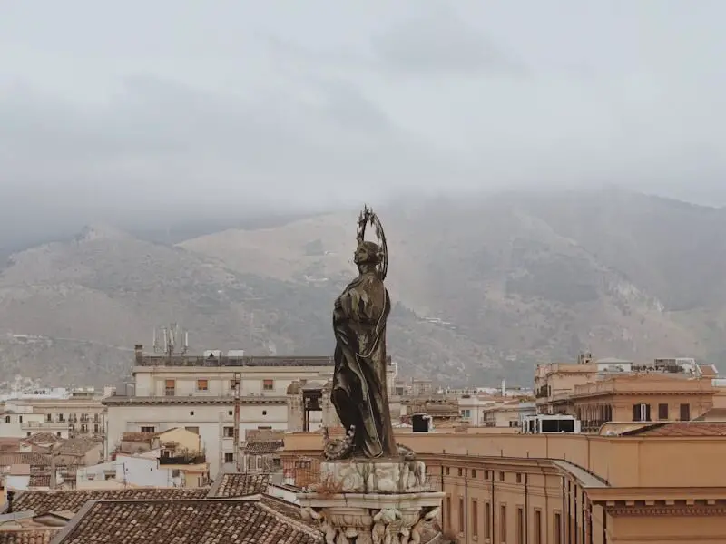 statue of man on top of building