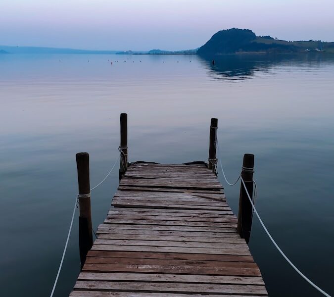 a wooden dock in the middle of a body of water