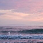 ocean waves crashing on shore during daytime