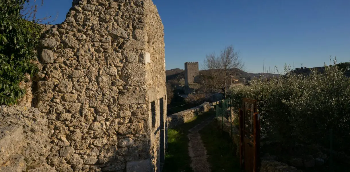 an old stone building with a path between it
