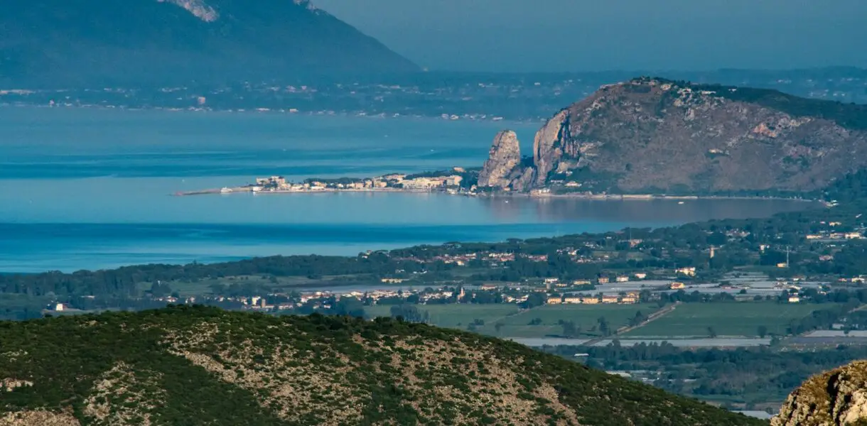 brown and green mountains near body of water