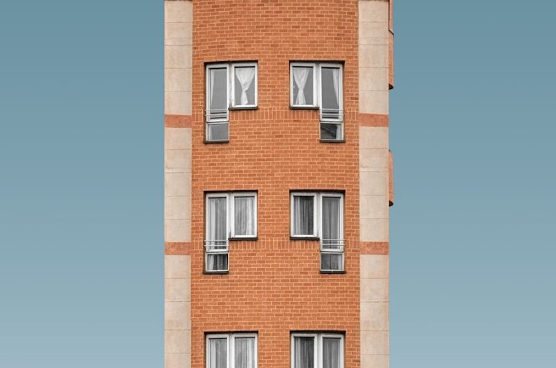 A tall brick building with many windows