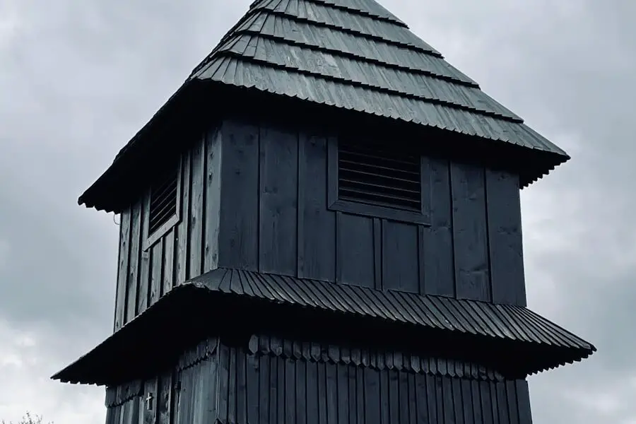 black wooden house near green trees during daytime